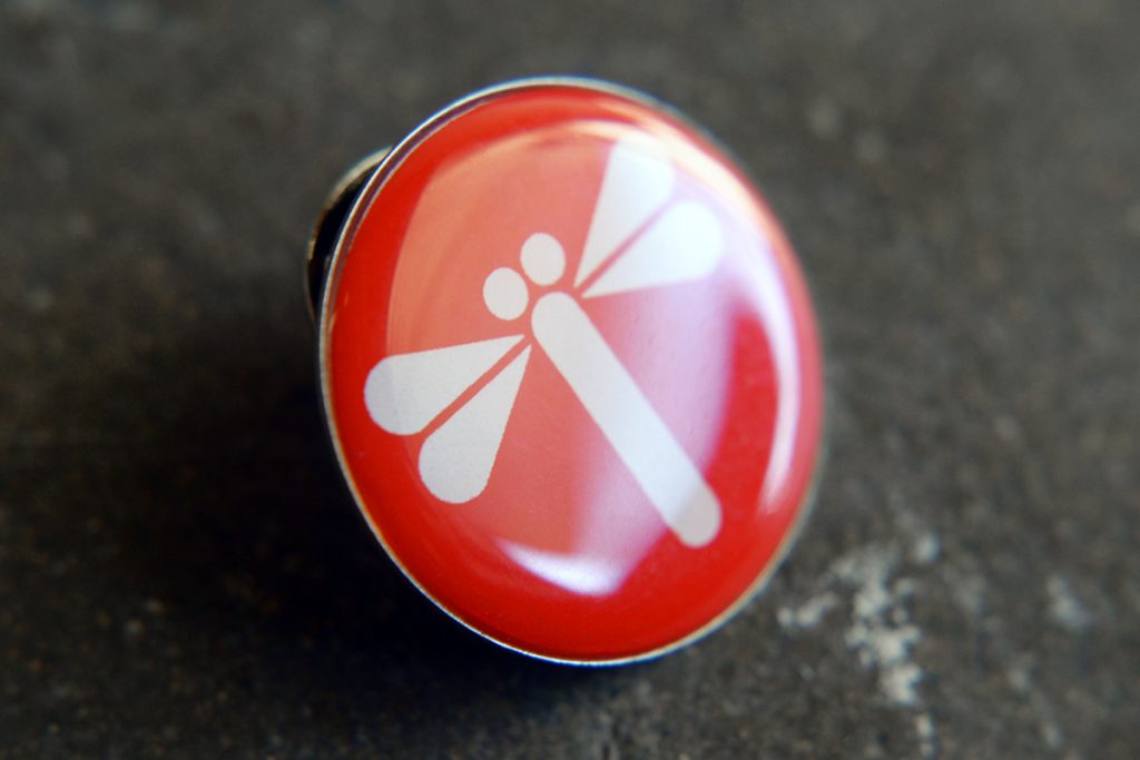 An enamel pin of JTF logo