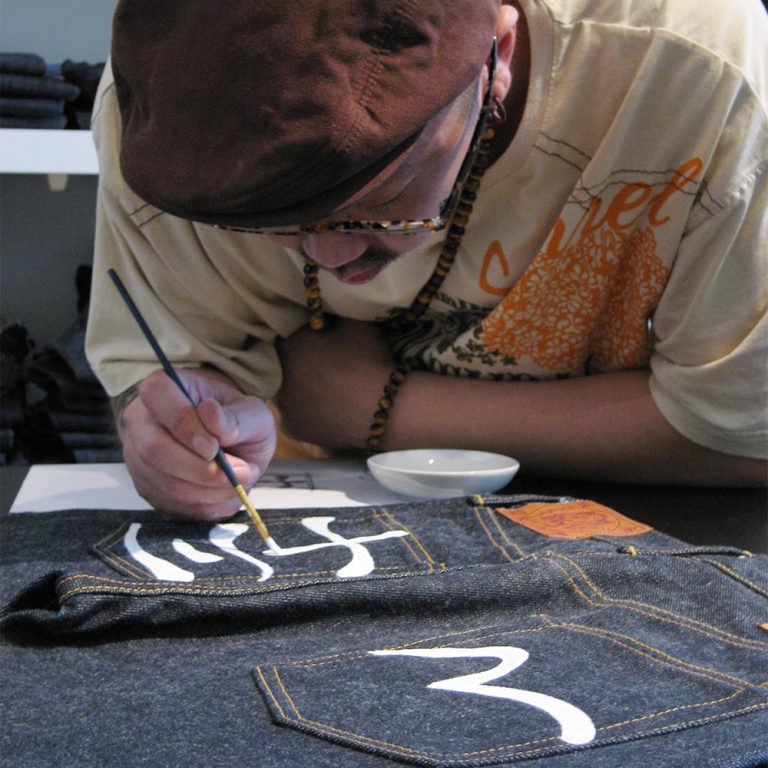 local artist painting the back pockets