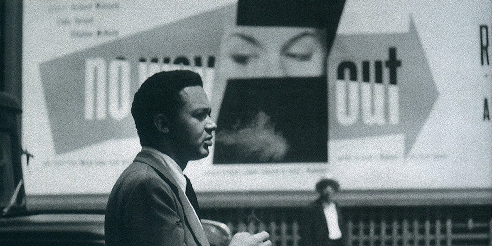 Paul Rand in front of his "No Way Out" billboard